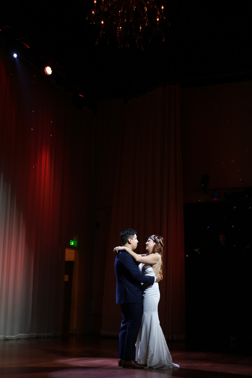 bride and groom dancing in spotlight