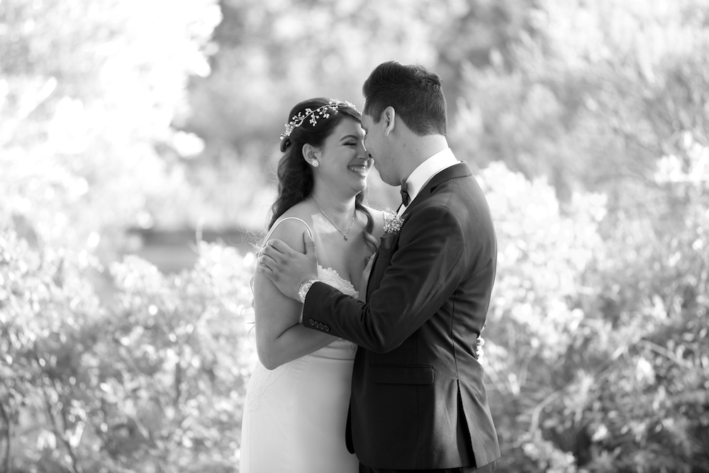 bride and groom embracing in black and white
