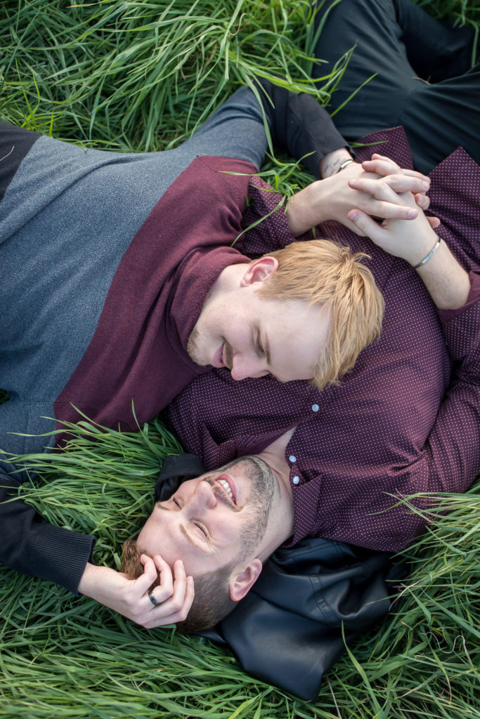 gay couple laying in grass