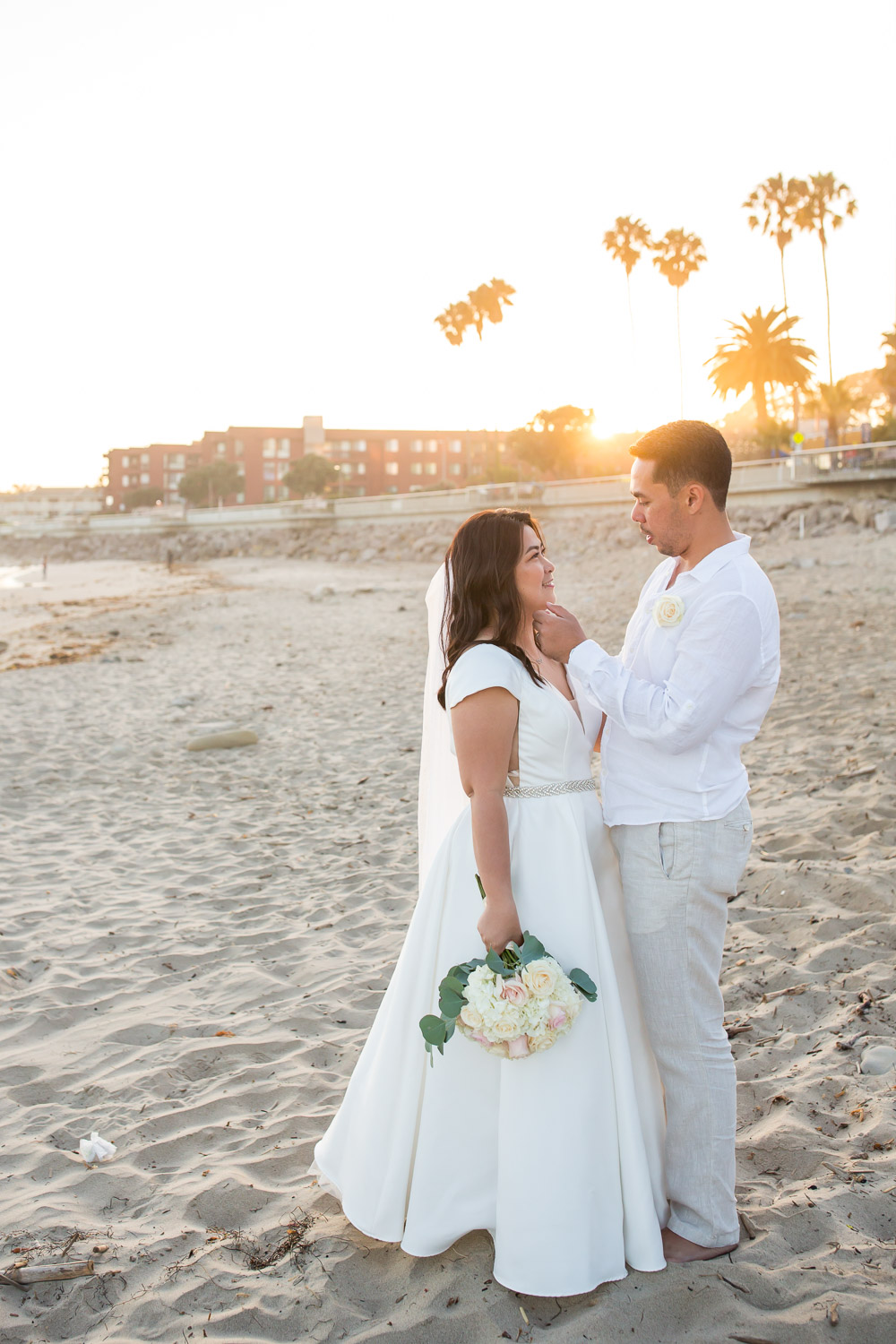 bride and groom on beach at crowne plaza