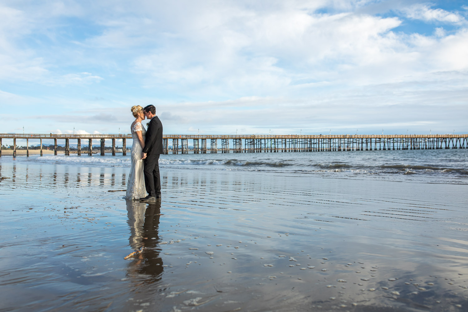 bride and groom on ventura beach during low tide