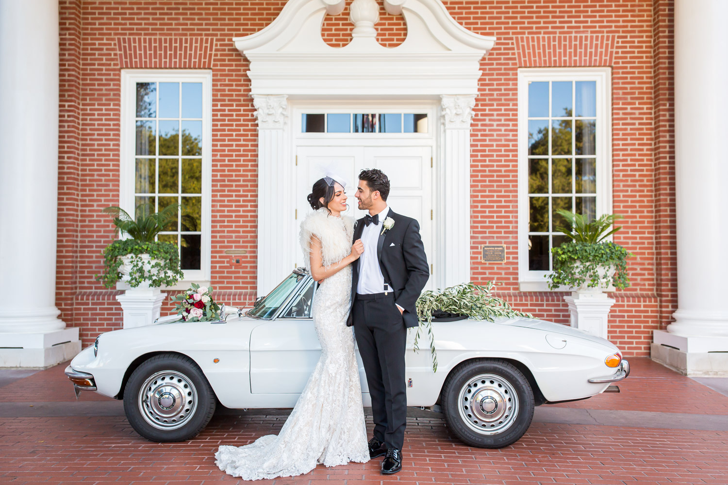 bride and groom in front of alfa romero and sherwood country club