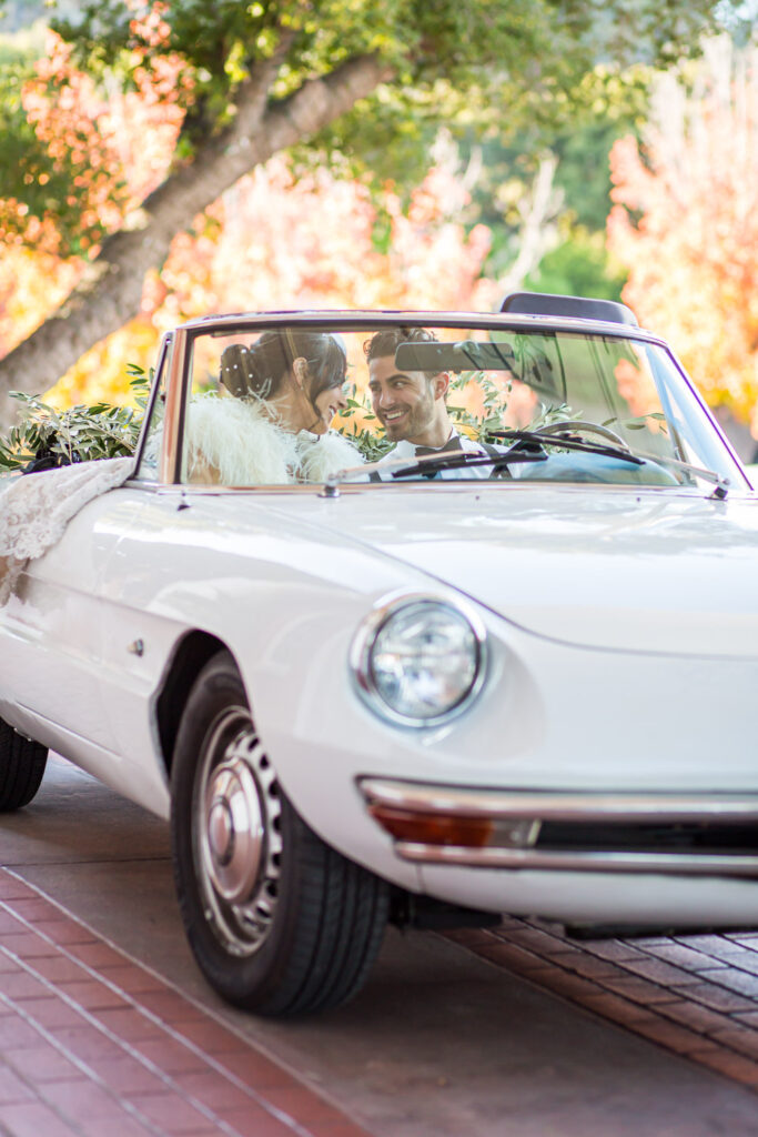 bride and groom driving alfa romera car