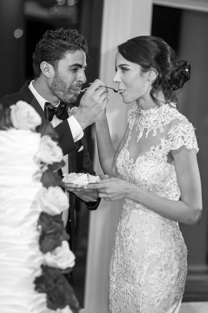 bride and groom tasting wedding cake