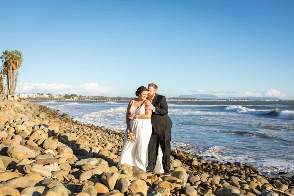 bride and groom on rocky beach ventura