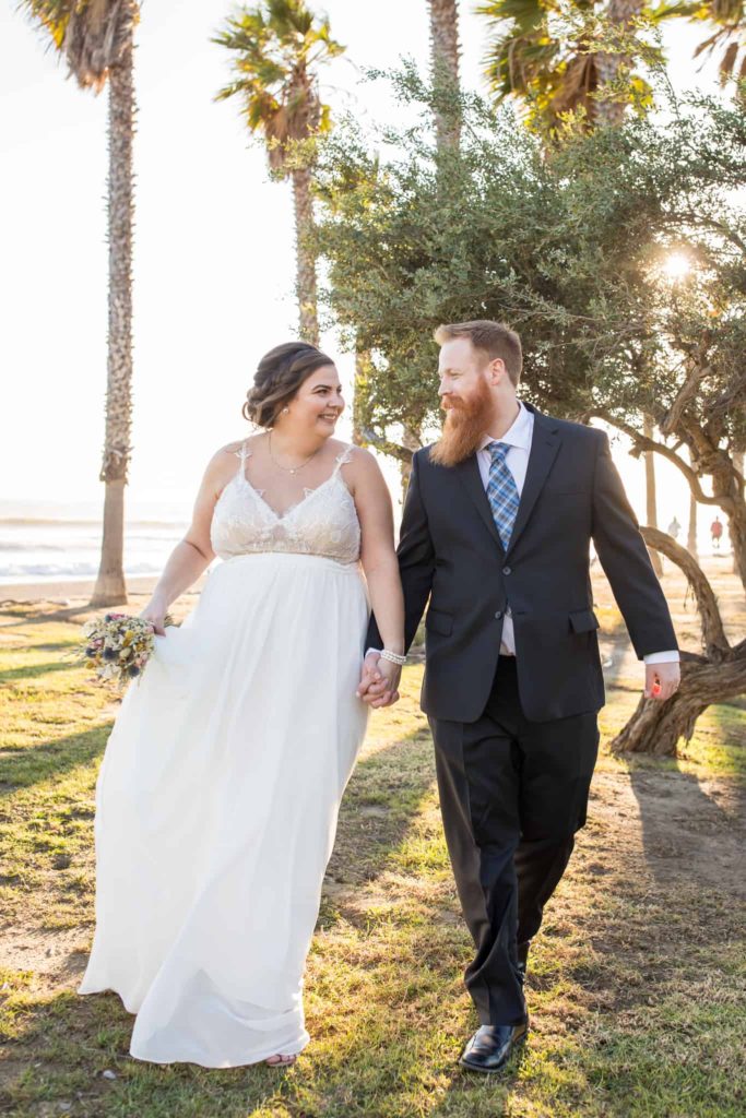bride and groom walking ventura beach
