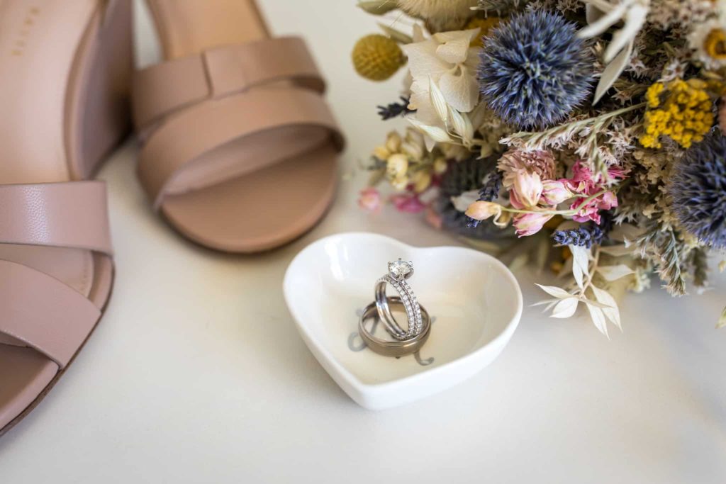 ring dish by shoes and flowers crowne plaza wedding