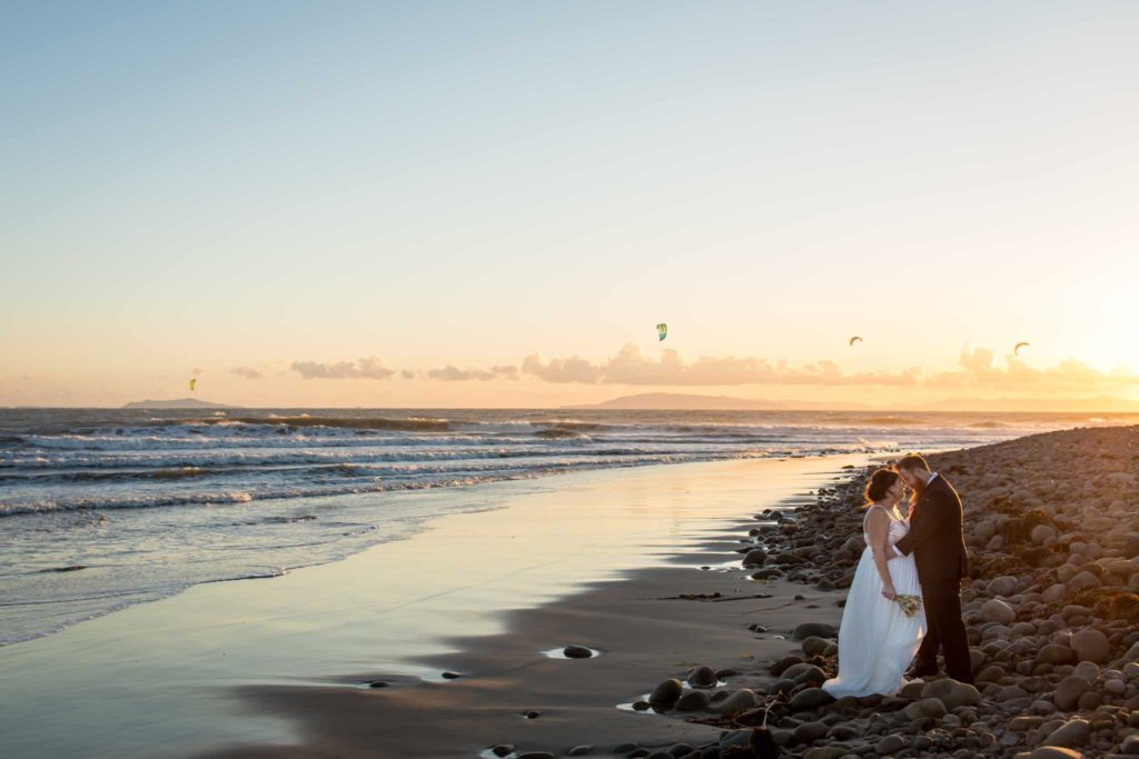 bride and groom on the beach at sunset in ventura