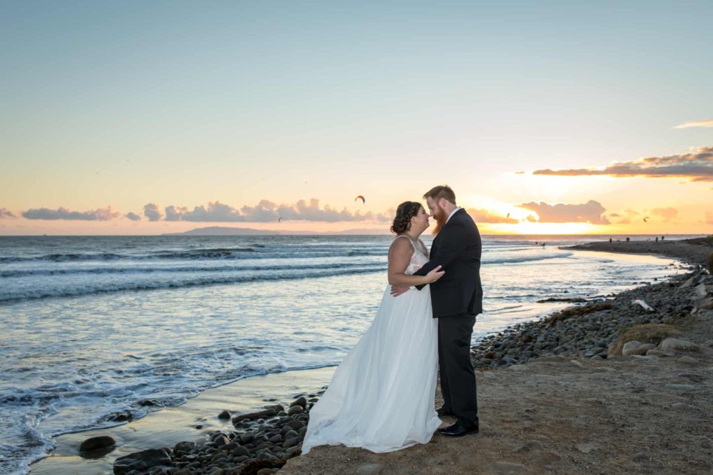 bride and groom on the beach crowne plaza ventura