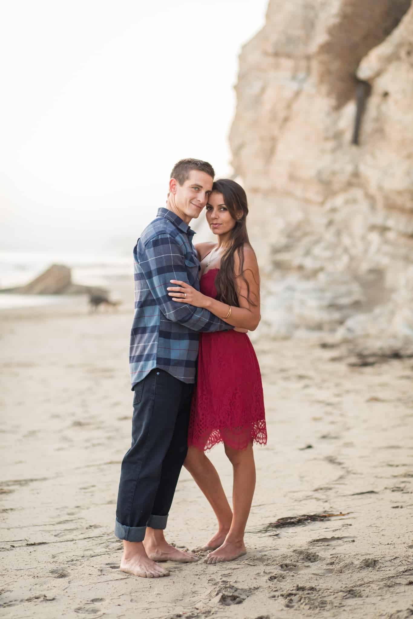 couple standing by beach cliffs santa barbara engagement session