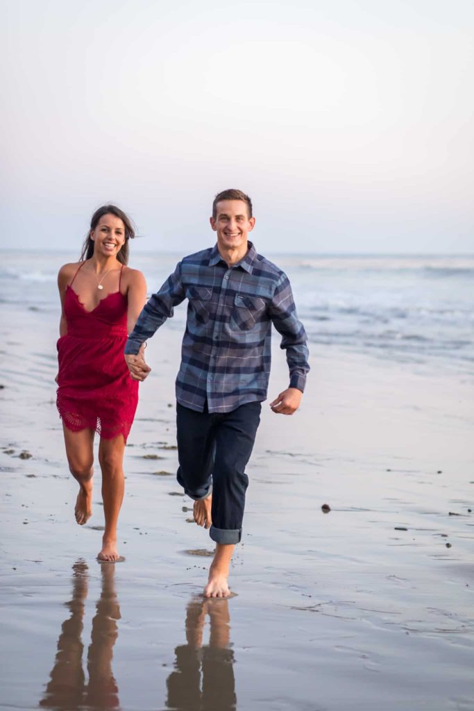 couple running on the beach santa barbara engagement session