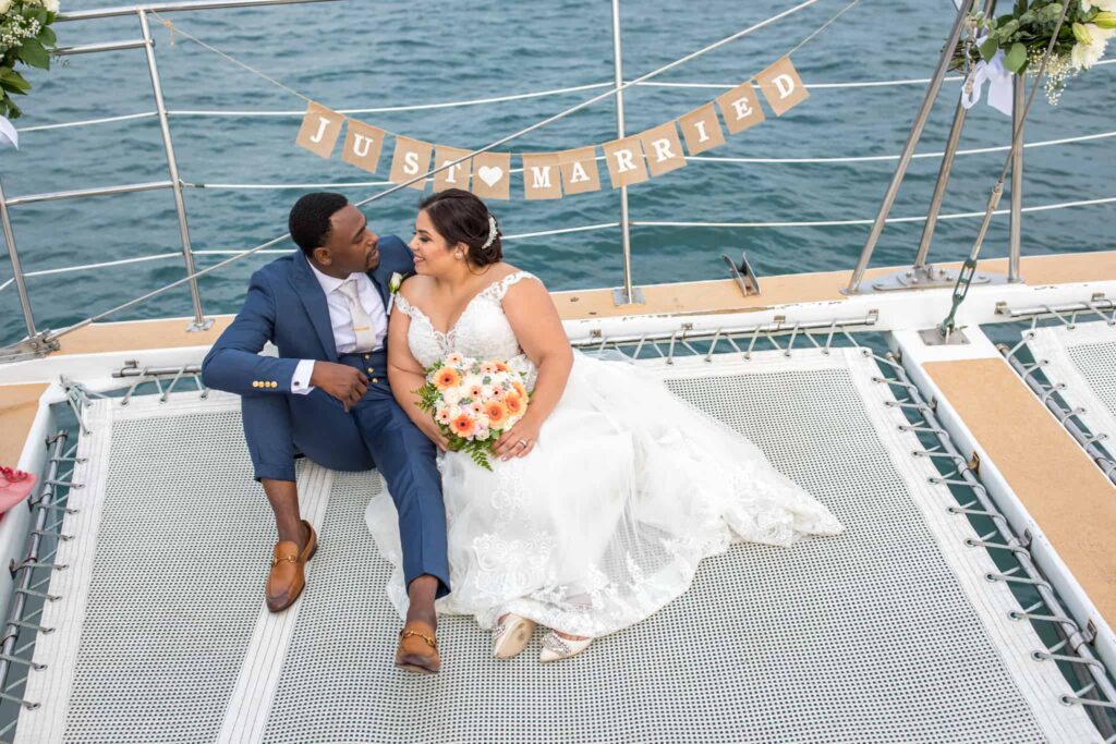 bride and groom sitting on yacht Santa Barbara Wedding