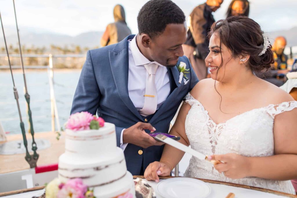 bride and groom cutting cake Santa Barbara Yacht Wedding