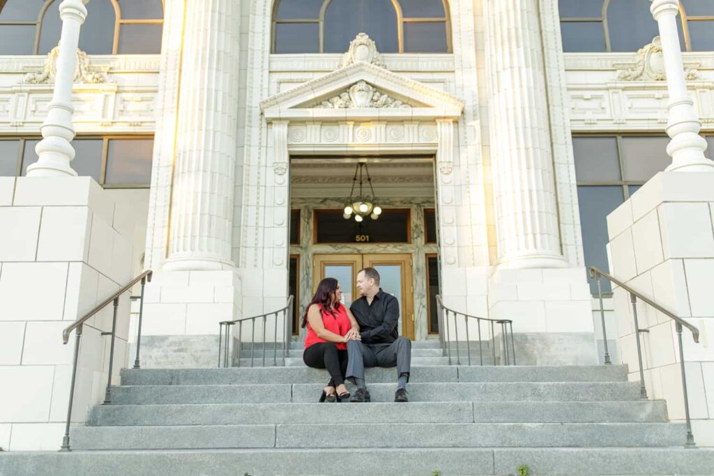 couple sitting on the steps of ventura city hall