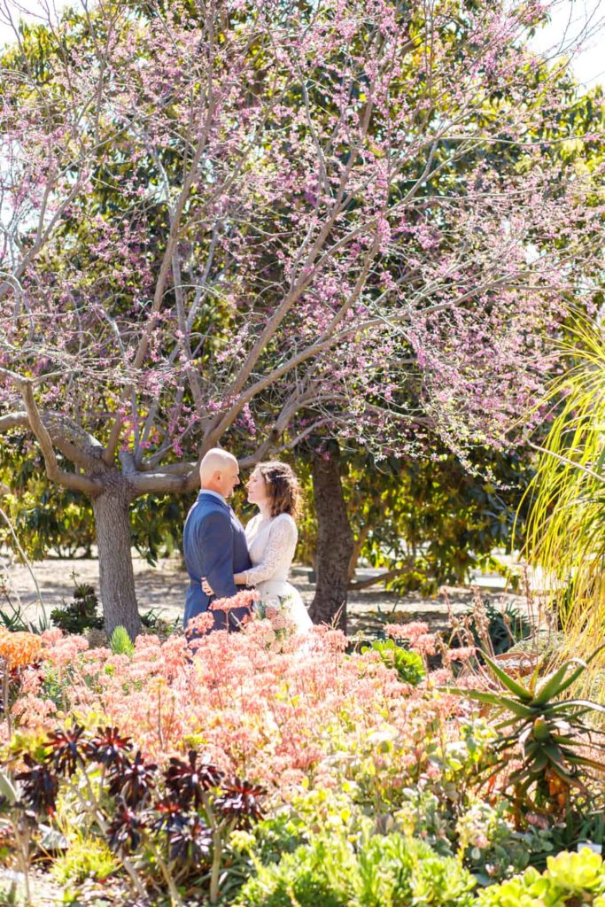 bride and groom in a colorful garden
