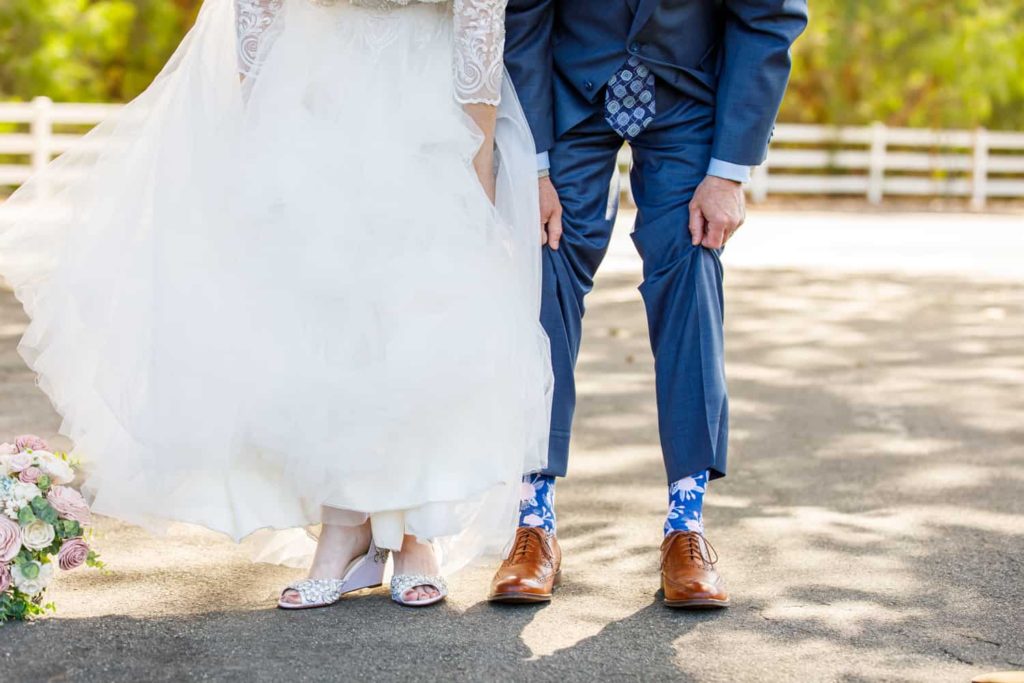 bride and groom showing their socks and shoes