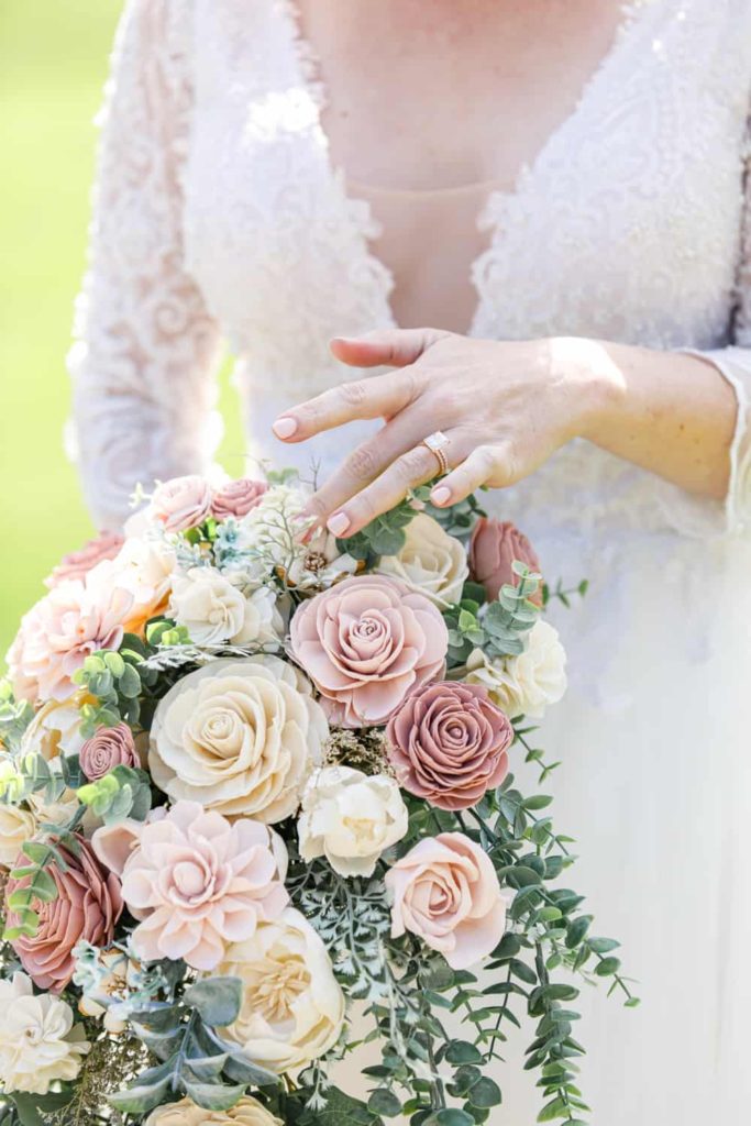 bride touching the flowers on her bouquet