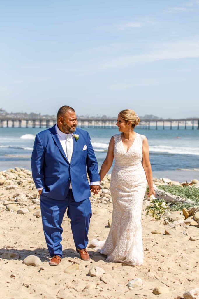 bride and groom walking at ventura beach