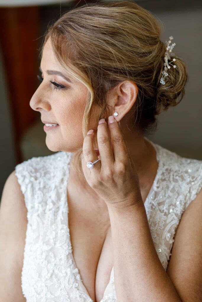 bride adjusting her earring