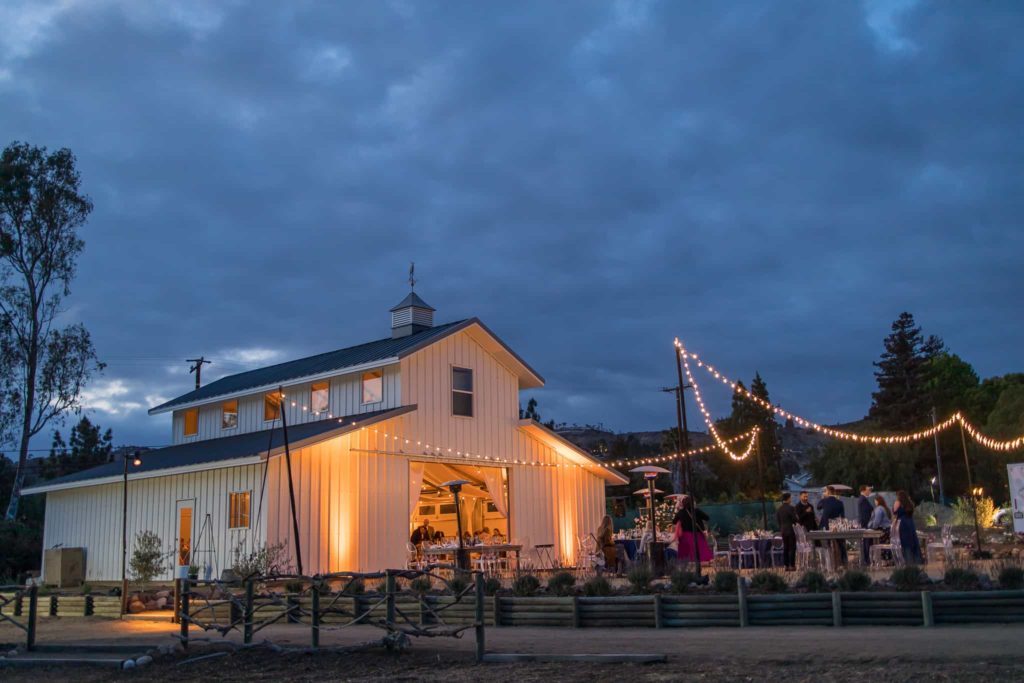 white barn in the evening at a wedding reception
