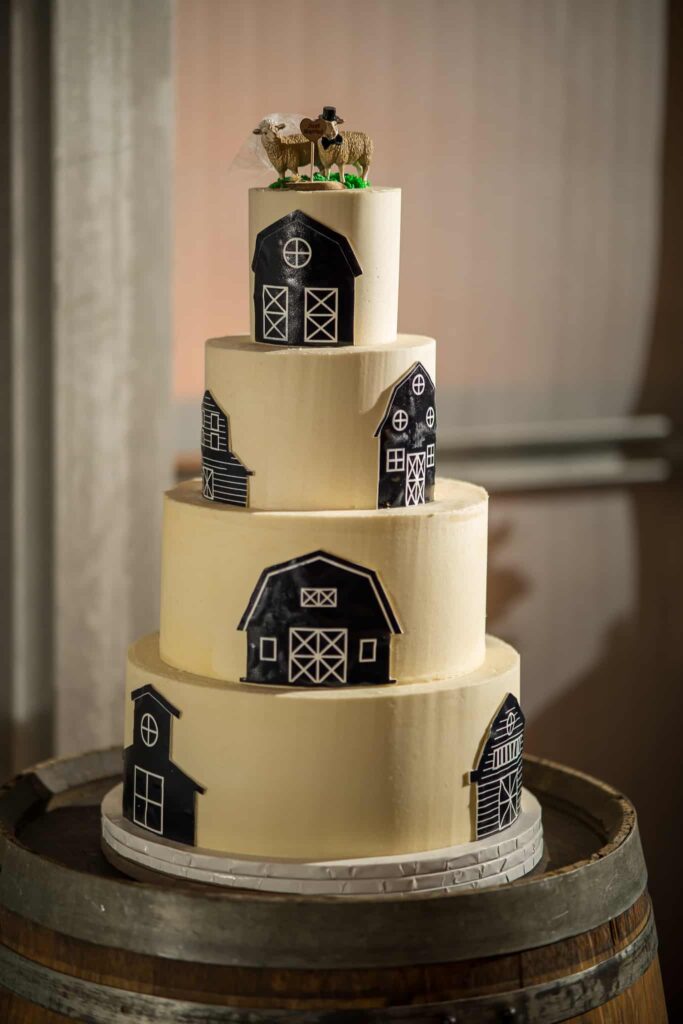 barn inspired wedding cake with sheep cake toppers