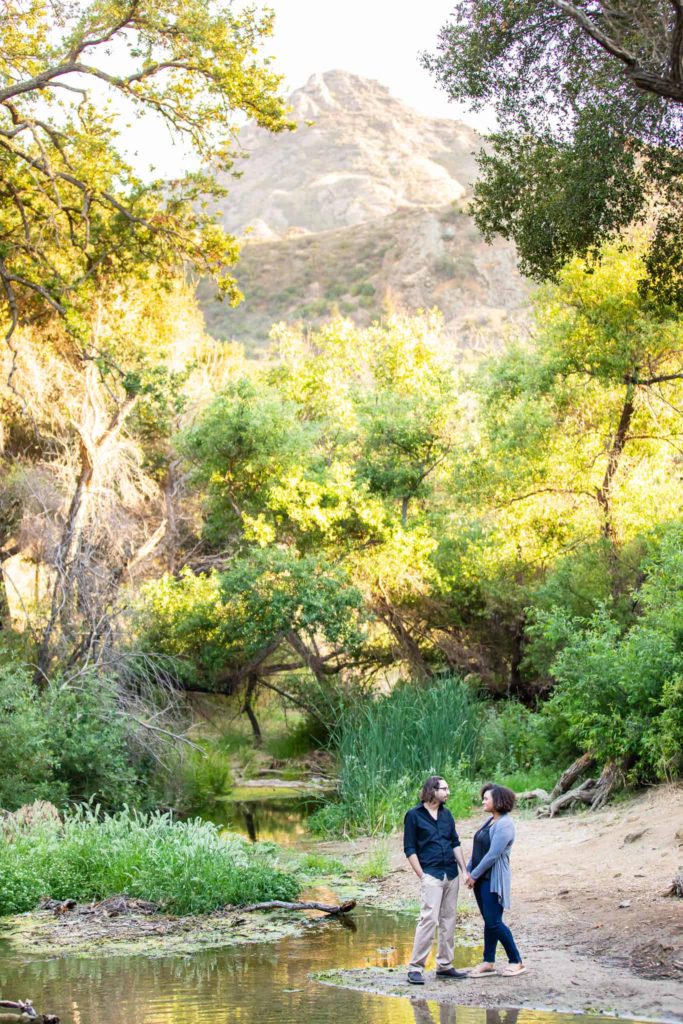 couple standing by a stream at malibu creek state park