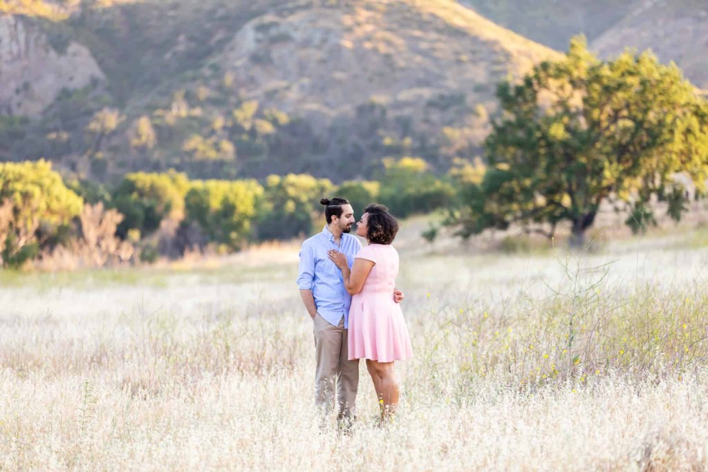 couple standing in a field at malibu creek state park