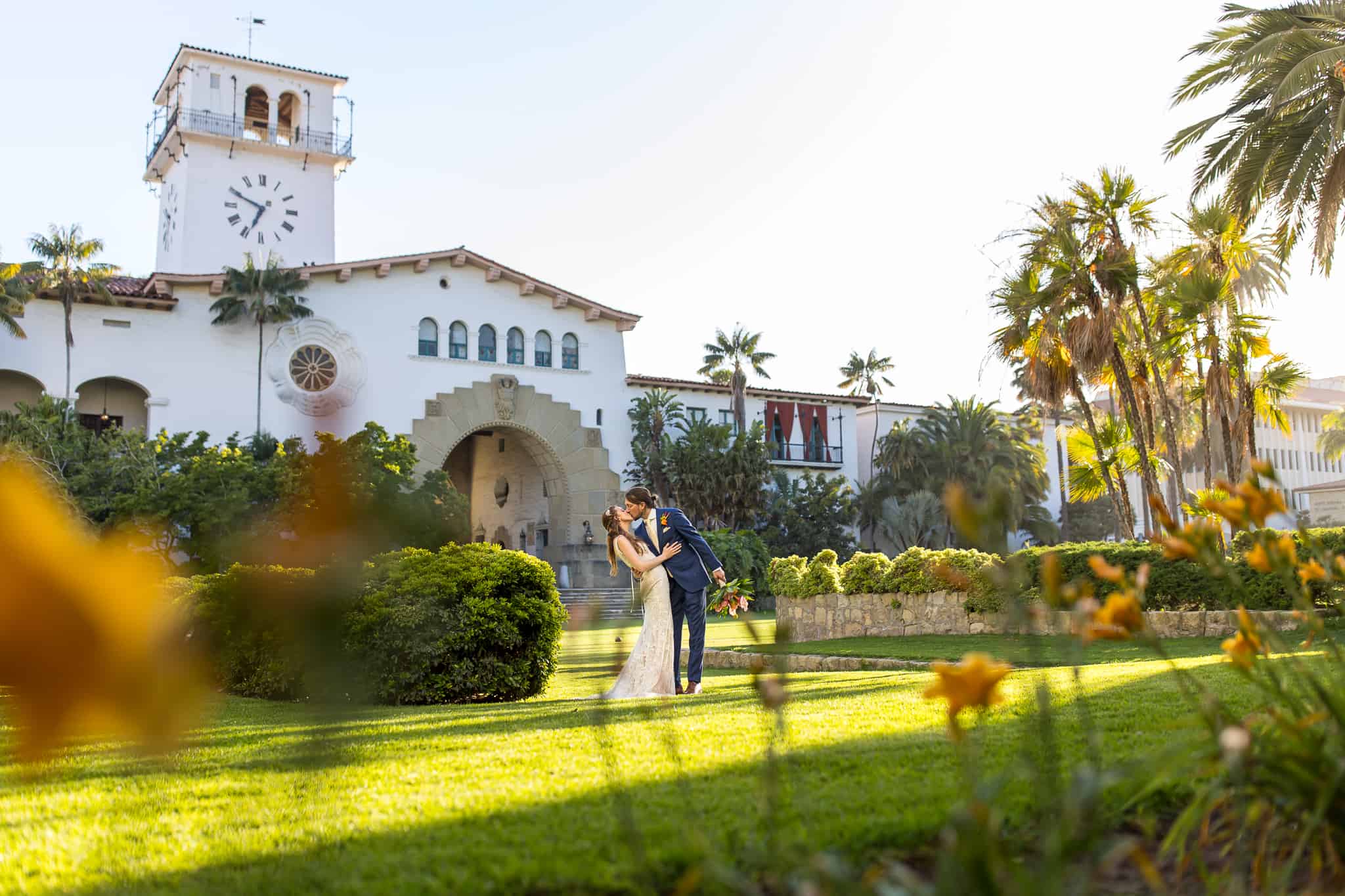 bride kissing in front of the santa barbara courthouse