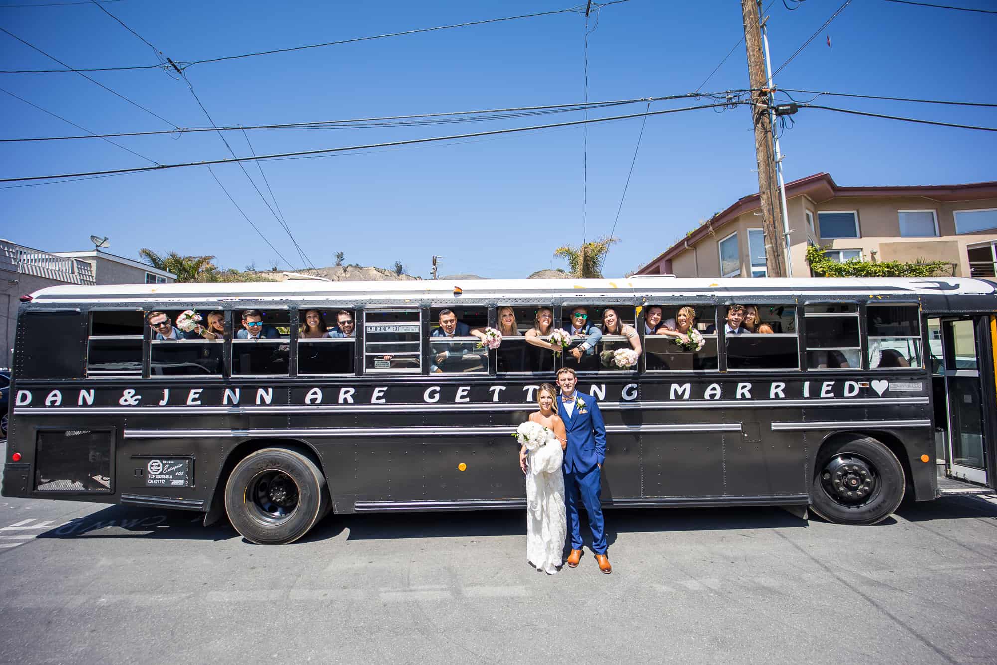 bride and groom and wedding party on party bus