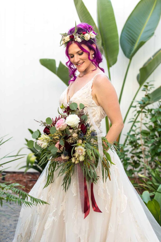 bride looking at her wedding bouquet