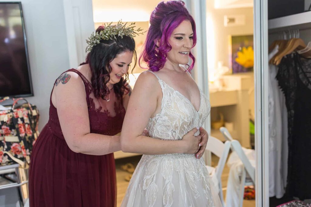 bride getting her wedding dress on