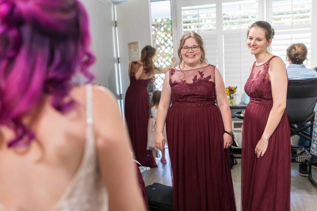 bridesmaid's seeing bride in her dress