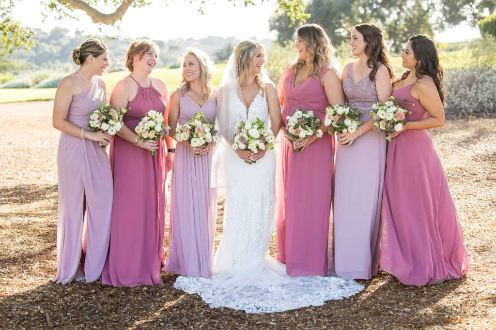 bride with her bridesmaids in pink and lavender gowns