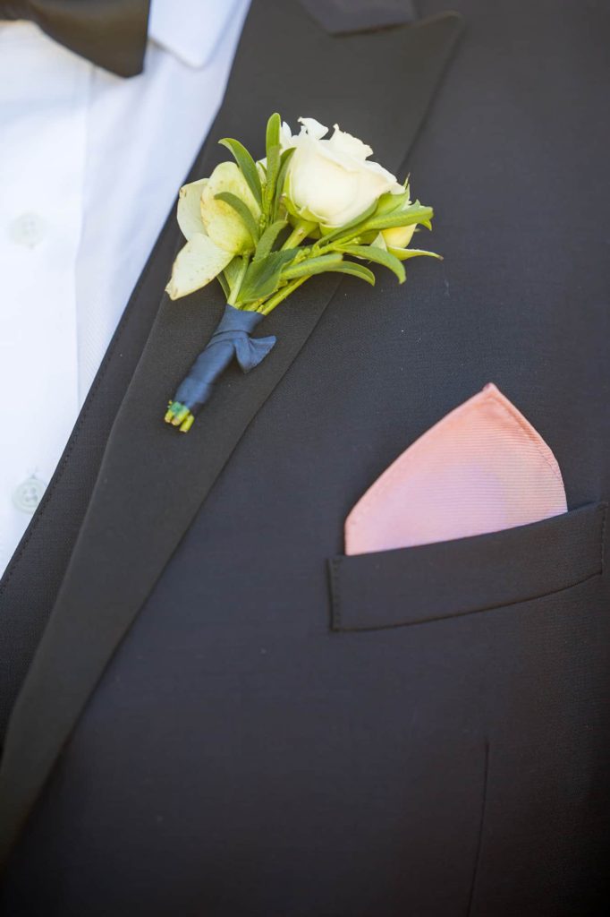 groom's boutonnière with pink handkerchief