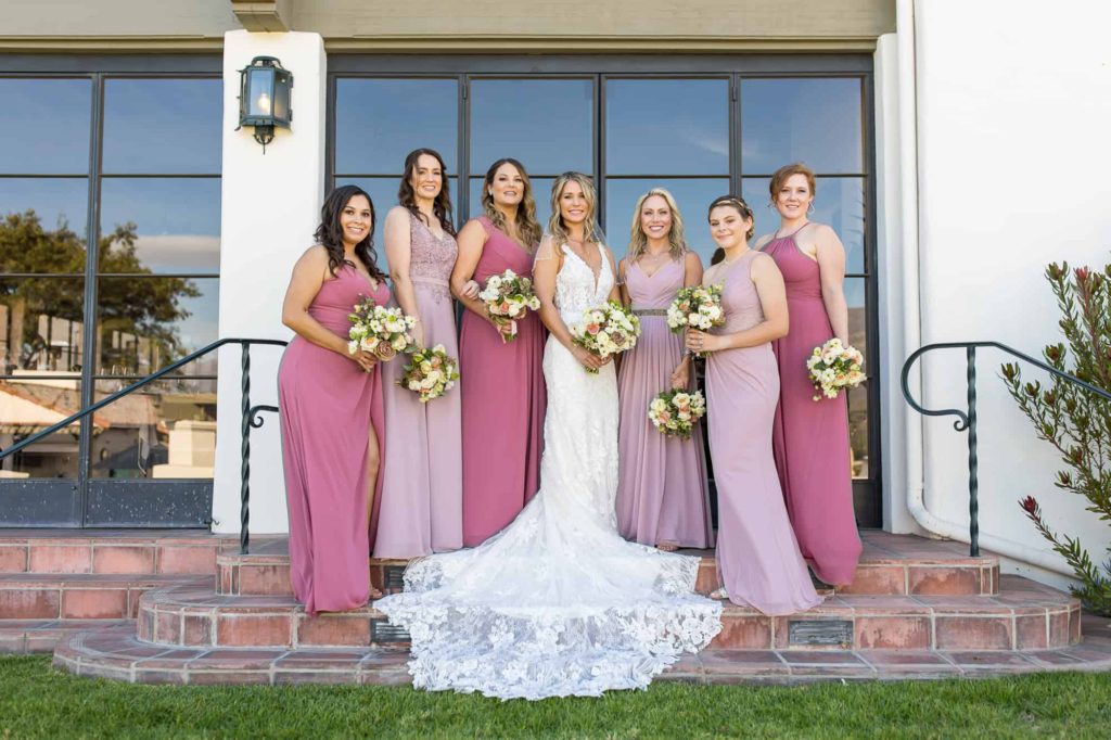 bride and bridesmaids in pink and lavender dresses