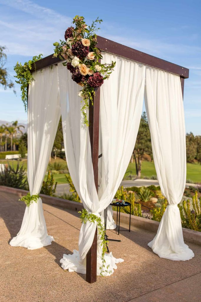 chuppah with white drapes at la cumbre country club