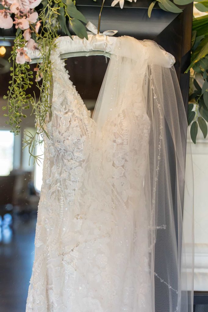 wedding dress hanging with veil