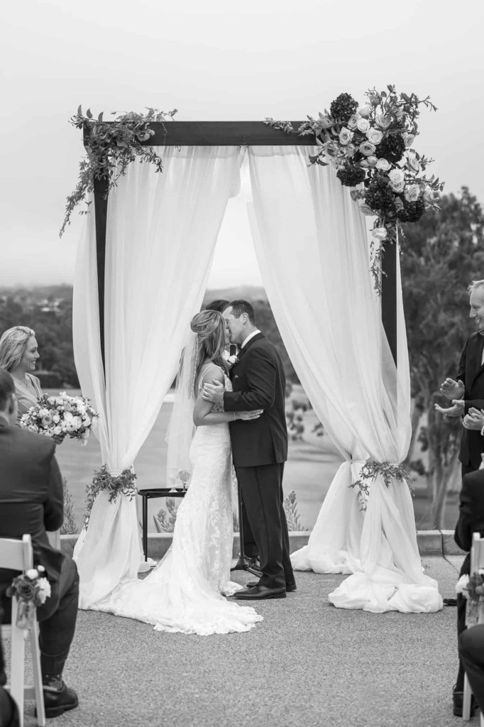 bride and grooms first kiss at la cumbre country club wedding