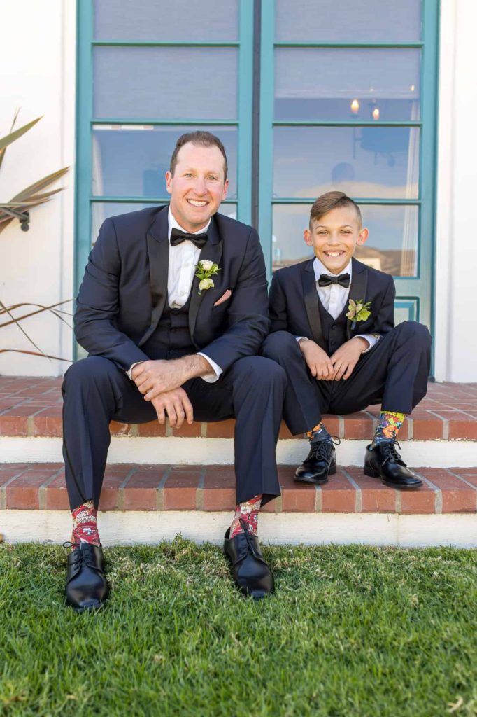 groom sitting with ring bearer