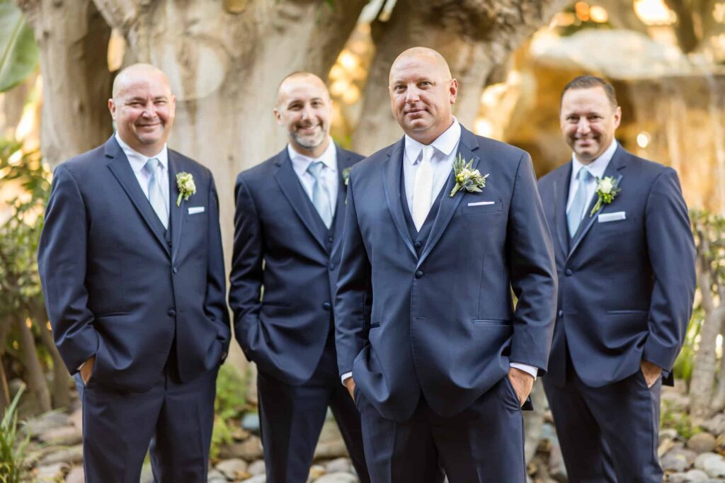 groom with his groomsmen in navy blue suits