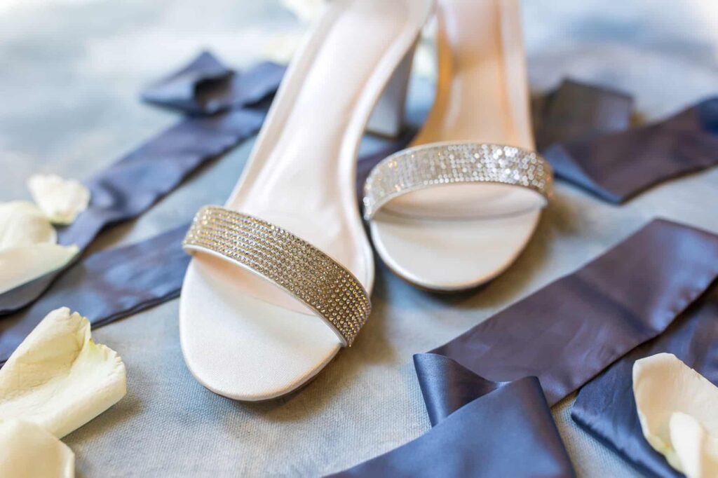 brides shoes with diamond details and blue ribbon
