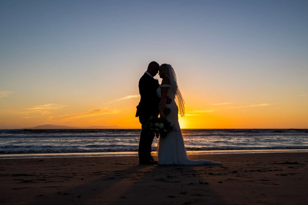 bride and groom on mandalay beach at sunset