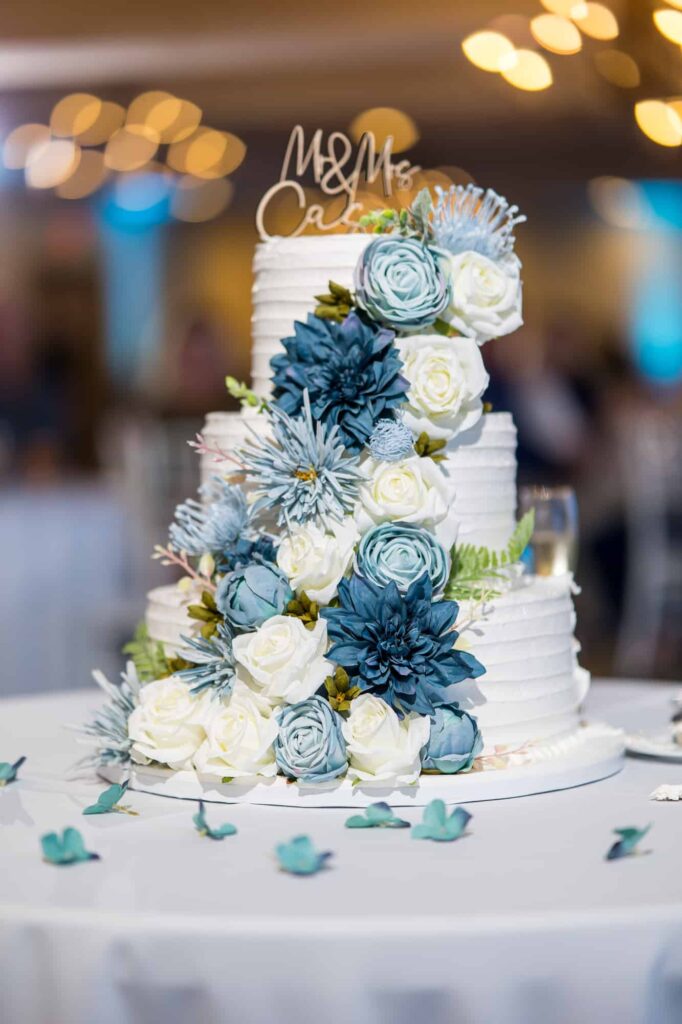 3 tiered wedding cake with blue flowers