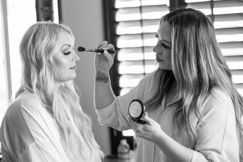 bride getting her makeup done at her wedding