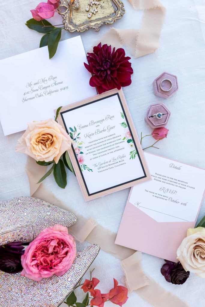 wedding invitation suite with pink flowers flat lay