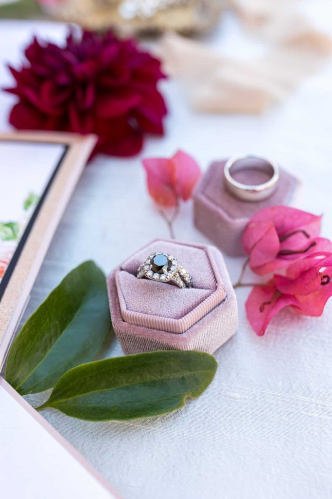 brides wedding ring in a pink velvet ring box flat lay