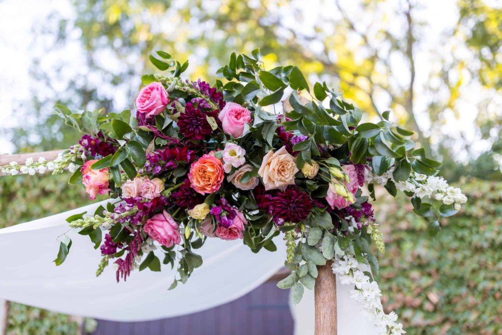 colorful flowers on chuppah at wedding ceremony los robles greens
