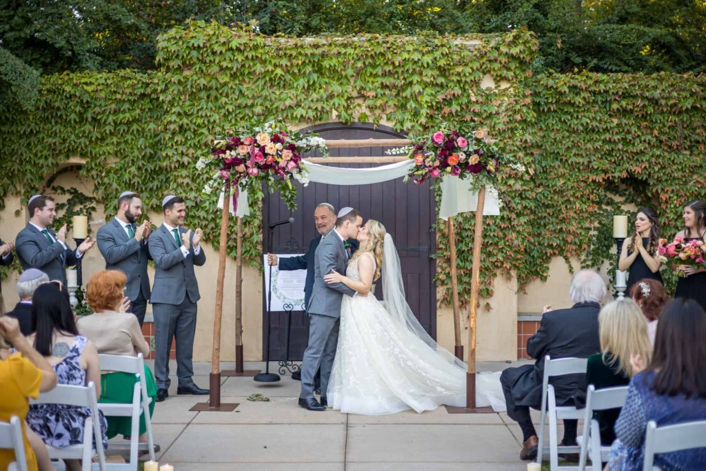 bride and grooms first kiss at los robles greens