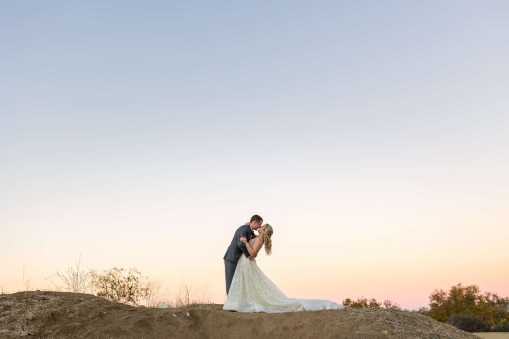 bride and groom kissing on a hill in thousand oaks