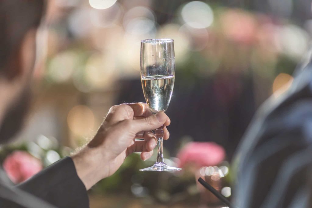 champagne flute held up during toast